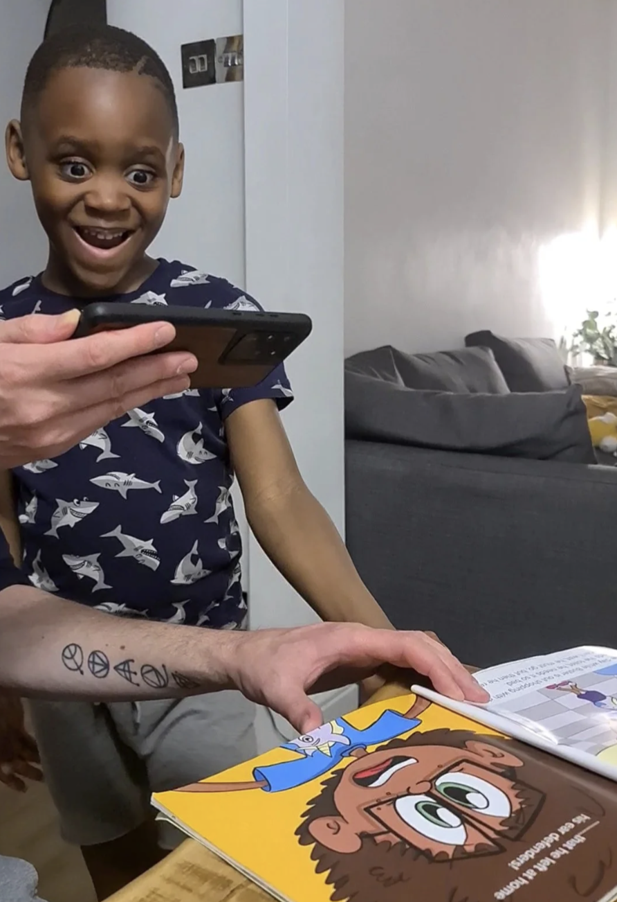 Boy reacts to the book shown as interactive